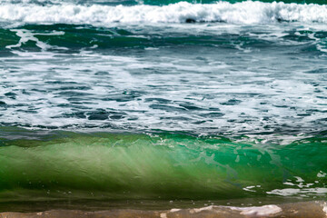 Sunlight filtering through the green waves of the sea