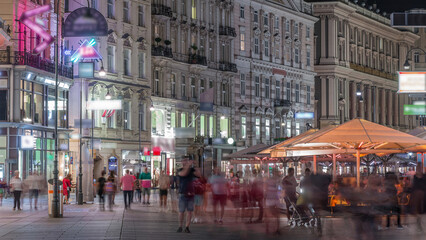 Fototapeta premium People is walking in Graben St. night timelapse, old town main street of Vienna, Austria.