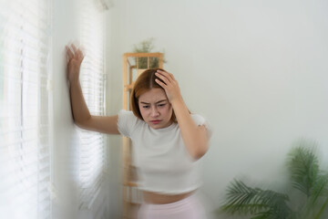 Dizzy asian young woman, woman headache or migraine pain. suffering from vertigo, difficulty...