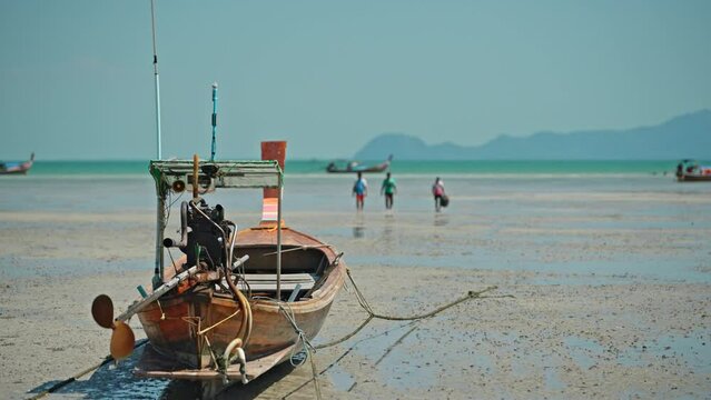 Traditional wooden boat of the locals on the beach on Koh Mook Island.
