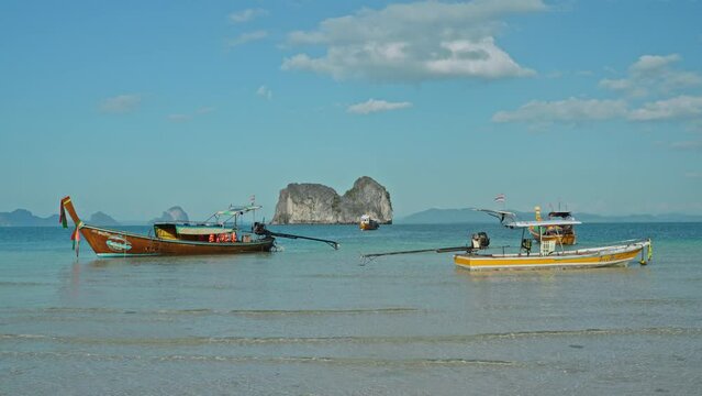 Traditional wooden boat of the locals on the beach on Koh Mook Island.