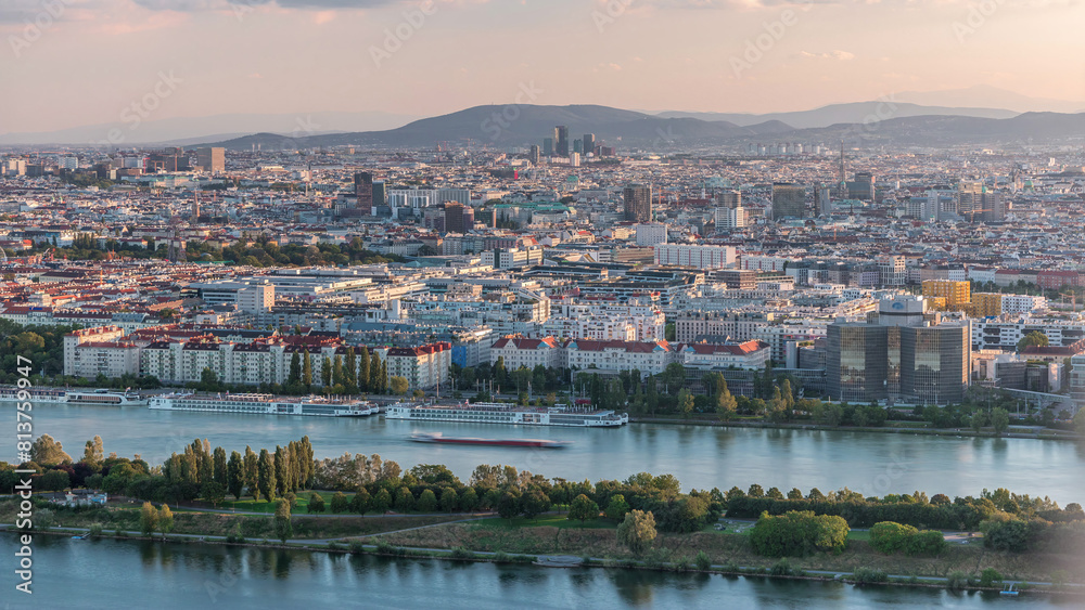 Wall mural Aerial panoramic view of Vienna city with skyscrapers, historic buildings and a riverside promenade timelapse in Austria.