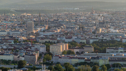 Aerial panoramic view of Vienna city with skyscrapers, historic buildings and a riverside promenade timelapse in Austria.