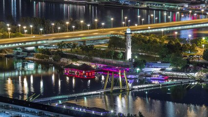 Fototapeta premium Aerial panoramic view over Vienna city with skyscrapers, historic buildings and a riverside promenade night timelapse in Austria.