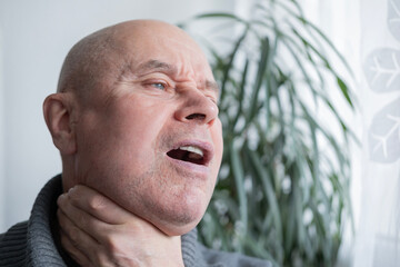 mature male neck, man patient holding affected area, experiencing throat pain, Health concern, loss of voice, various causes, tonsillitis