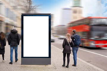 vertical Mockup billboard stands, people walk and transport move in city, blank white screen...