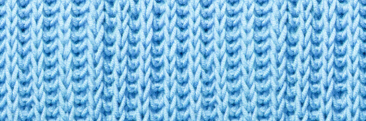 beautiful blue knitted braid pattern of light wool yarn, seamless knitted texture, concept warm...