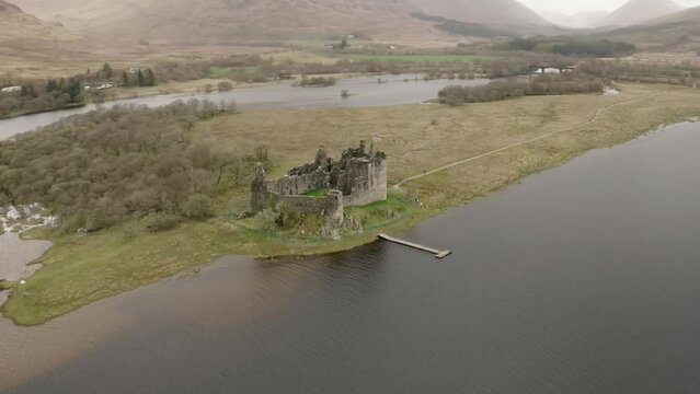 The Ruins Of Historic Kilchurn Castle And Jetty On Loch Awe, Argyll, Scotland