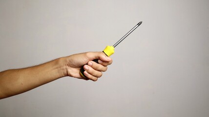 a man's hand holding a screwdriver