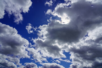 Sunbeams breaking through dramatic cumulus clouds. Change of weather. Hope or religion concept.