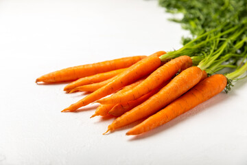 Carrots on a textured wooden background. Fresh and sweet organic carrots on a white background. Carrot slices. Vegan. Ingredients for salad. Place for text. Copy space. Flatley