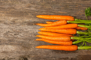 Carrots on a textured wooden background. Fresh and sweet organic carrots on a white background. Carrot slices. Vegan. Ingredients for salad. Place for text. Copy space. Flatley