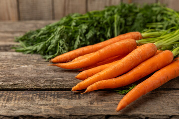 Carrots on a textured wooden background. Fresh and sweet organic carrots on a white background. Carrot slices. Vegan. Ingredients for salad. Place for text. Copy space. Flatley