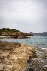 Obraz premium Rocky beach in the Victoria town in Mallorca Spain on a cloudy summer day
