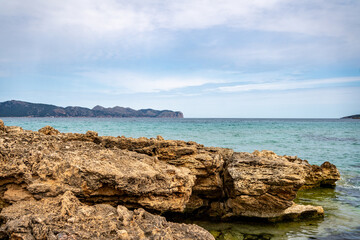Rocky beach in the Victoria town in Mallorca Spain on a cloudy summer day