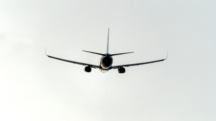 Airplane in the sky at sunset or dawn in the sun's rays