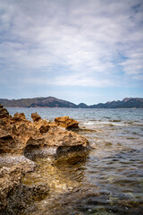 Rocky beach in the Victoria town in Mallorca Spain on a cloudy summer day