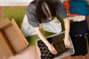 Teenage student packing things to move, carrying heavy boxes down dormitory hallways, campus...