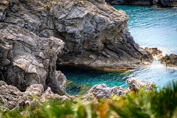 Naklejka premium sea side shore in la victoria town in mallorca spain on a chilly day - blue waters and blue sky