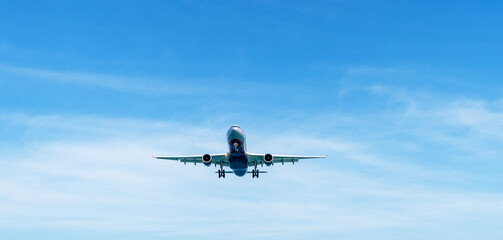 Airplane in the sky at sunset or dawn in the sun's rays