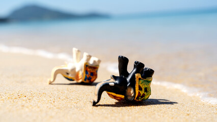 Elephant figurine on the beach in the sun