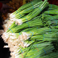 Bunch of fresh spring onions at a market