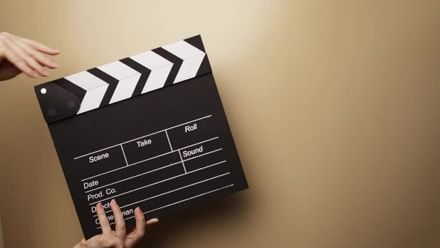 Hands with video clapper, recording the moment, cinema industry in action