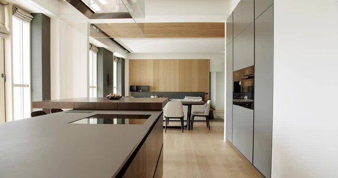 Modern contemporary Minimalist living room with wooden wall and gray furniture. Luxury Modern House Interior With Corner Sofa and Bookshelf. Fashionable furniture. Minimalist Home Interior.
