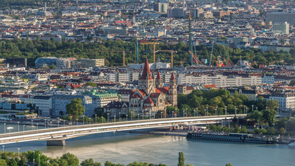 Obraz premium Aerial panoramic view of Vienna city with skyscrapers, historic buildings and a riverside promenade timelapse in Austria.