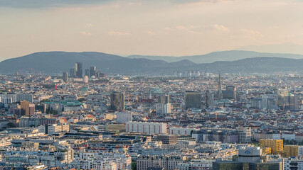 Aerial panoramic view of Vienna city with skyscrapers, historic buildings and a riverside promenade timelapse in Austria.