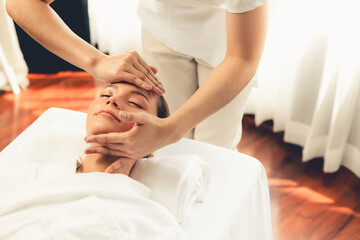 Caucasian woman enjoying relaxing anti-stress head massage and pampering facial beauty skin...