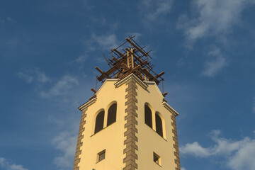 church tower during reconstruction, photographed in the evening