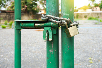 old rusty lock and a metal chain, bolted on a iron door close-up