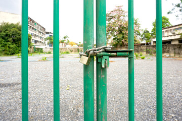 old rusty lock and a metal chain, bolted on a iron door close-up