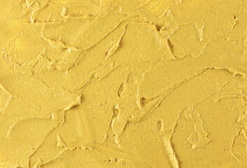 Yellow mustard sauce, spread background and texture, top view	