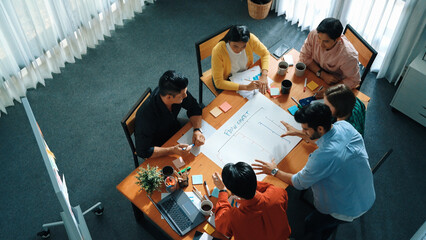 Top down view of diverse people brainstorming and making scrum task board. Group of skilled...