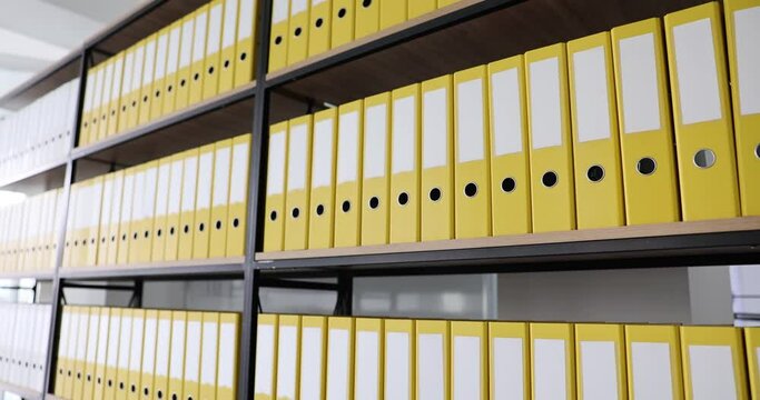 Office yellow folders on shelf in office. Archive documentation