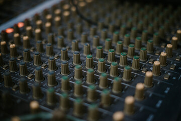 An audio mixer with its knobs and sliders meticulously adjusted, embodying precision and control in...