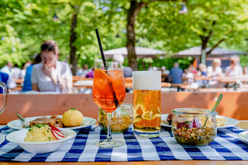 Sommerlicher Genuss im Biergarten – Aperol Spritz und kühles Bier bei Sonnenschein