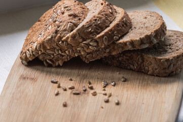 Sliced rye bread with sunflower seeds on a cutting board