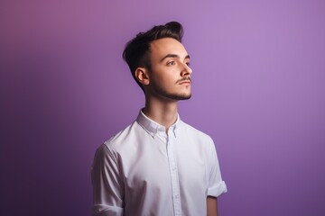 Fototapeta premium A man in a white shirt is standing in front of a purple background
