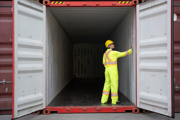 asian man container inspector examines shipping container for any signs of damage or issues that could effect the safety of goods,concept of quality control,cargo transportation,business,industry