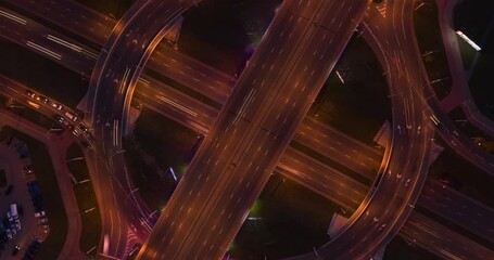 Many cars are driving on road at high speed and car interchange. Evening traffic on the road