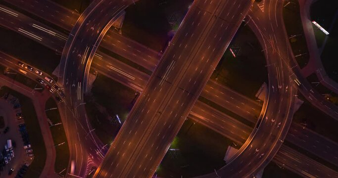 Many cars are driving on road at high speed and car interchange. Evening traffic on the road