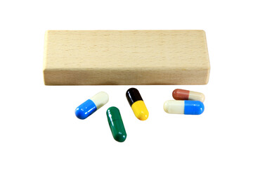 Empty wooden block for text or message short word english letter with capsule pills on brown wood pantern background.Copy space.