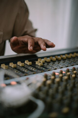 An audio mixer with its knobs and sliders meticulously adjusted, embodying precision and control in...
