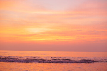 Fototapeta na wymiar A beautiful golden sunset over the ocean. Peach Nature Background