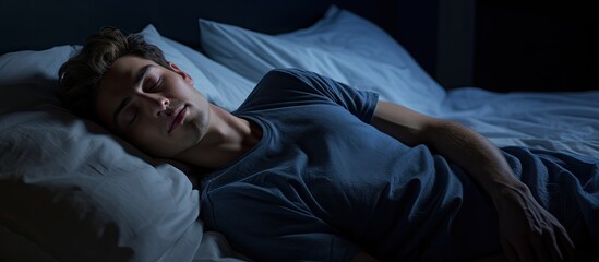 Copy space image of a serene young man peacefully asleep in a hotel room bed