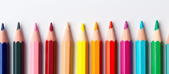 An assortment of six colored pencils positioned haphazardly against a blank backdrop for copy space image