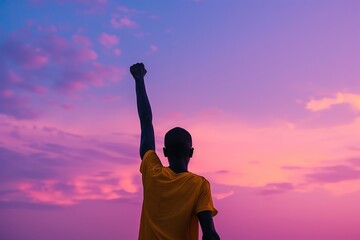 African American man Silhouette Raising Arms at Sunset Purple Sky Background. Confident Male Wearing a Sportswear. He is Standing in Winner Pose with Raised Hands. Leader Celebrating Success